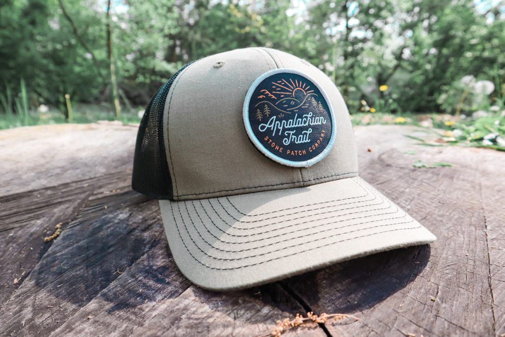 embroidered cap on a tree stump in the outdoors